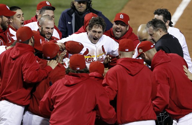 Teammates celebrate with St. Louis Cardinals‘ David Freese after Freese hit a walk-off home run during the 11th inning of Game 6 the World Series against the Texas Rangers on Thursday, Oct. 27, 2011, in St. Louis. The Cardinals won the game 10-9 to tie the Series 3-3. (AP Photo/Eric Gay)